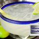 Margarita in a glass with salted rim beside some limes